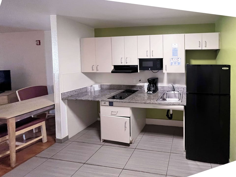Full-size fridge, microwave, stovetop, cookware/dishes/utensils