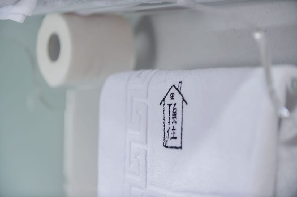 Quadruple Room | Bathroom | Shower, hair dryer, slippers, towels