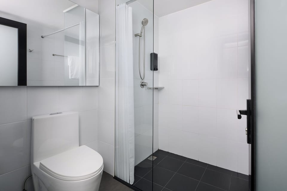 Twin Room | Bathroom | Shower, hair dryer, slippers, towels