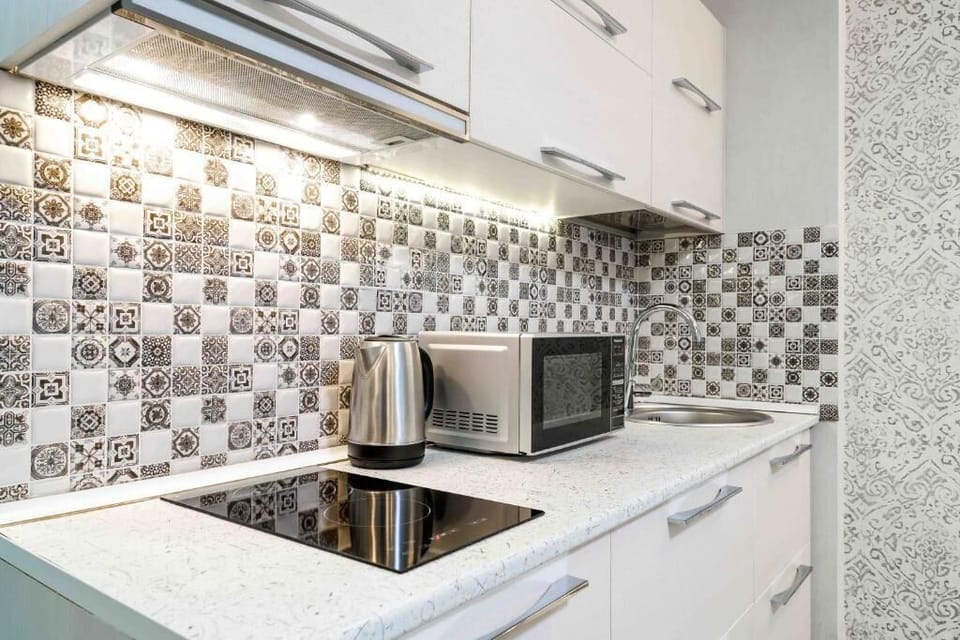 Deluxe Quadruple Room | Private kitchen | Espresso maker, dining tables