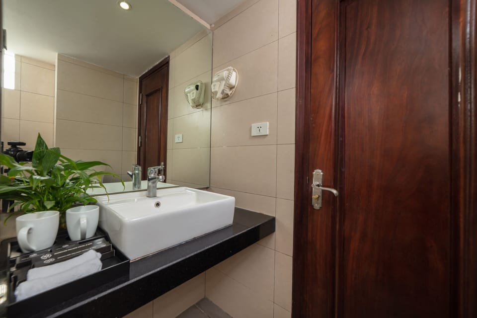 Designer toiletries, hair dryer, slippers, towels