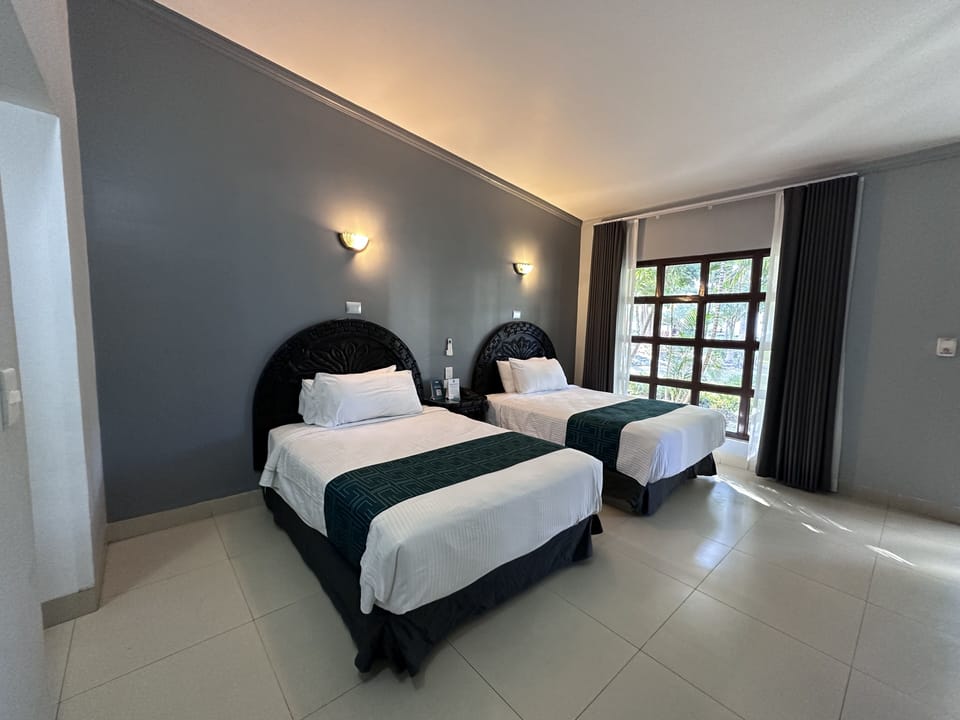 Standard Double Room, Pool View | Desk, laptop workspace, iron/ironing board, travel crib