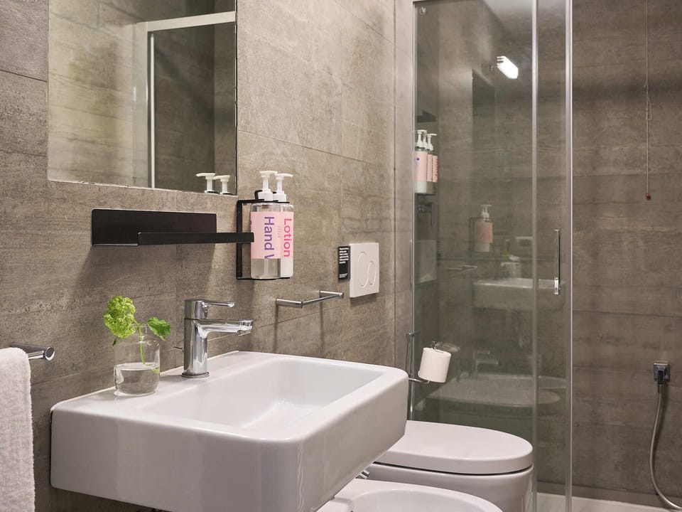 Shower, rainfall showerhead, designer toiletries, hair dryer