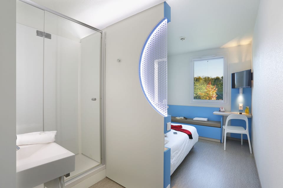 Premium bedding, desk, laptop workspace, blackout drapes