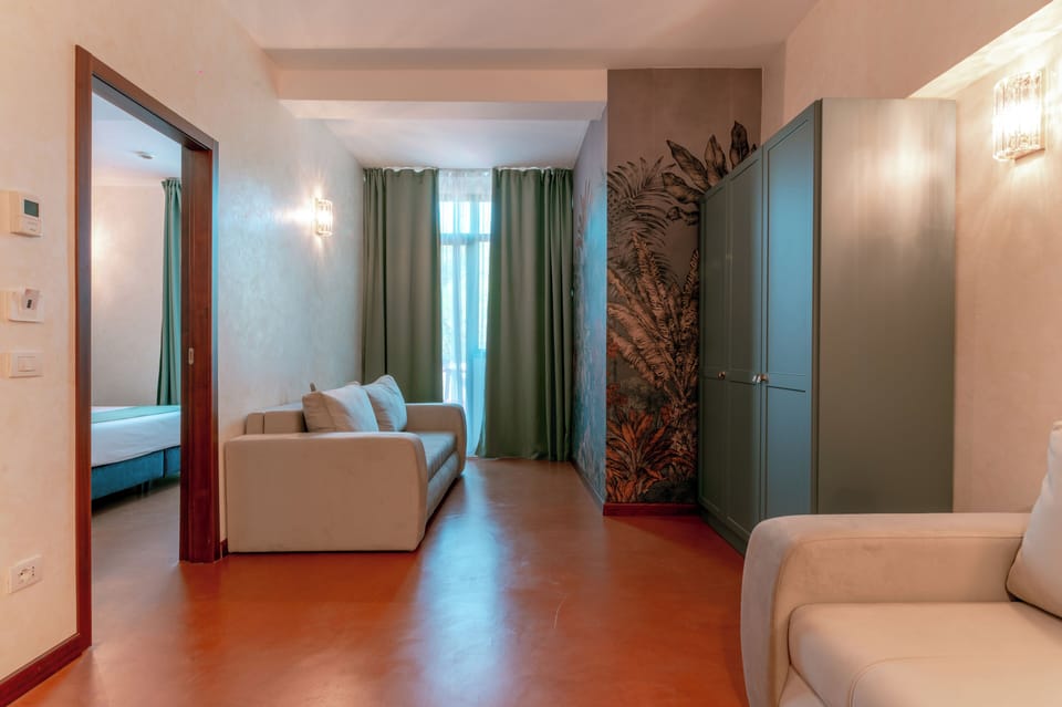 Junior Quadruple Room | Living area | 72-inch TV with digital channels