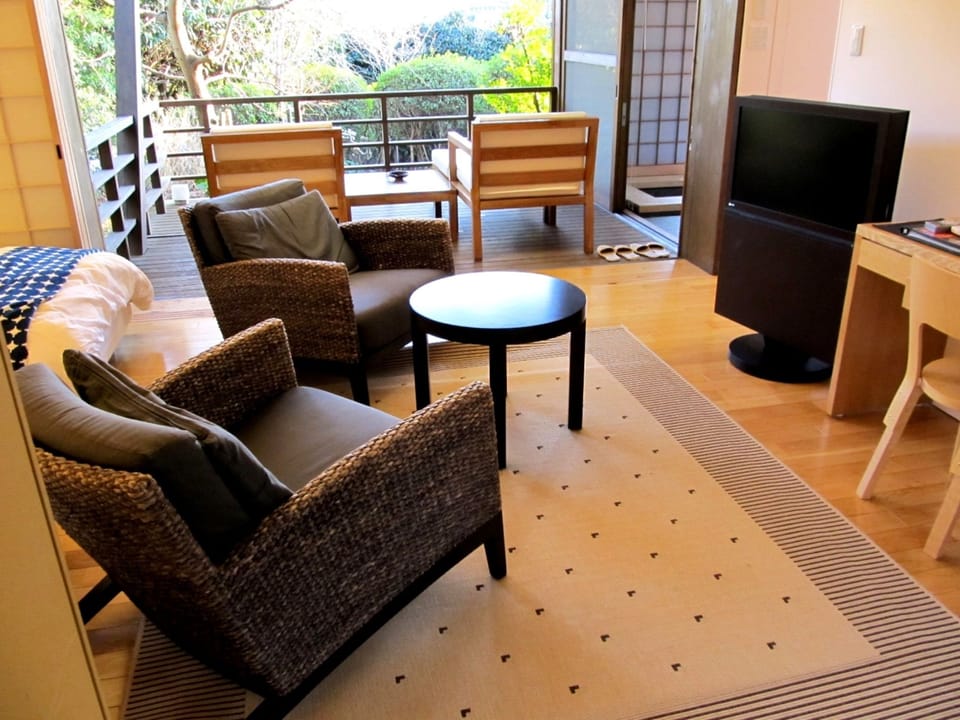 Suite Room with Private Semi-open Air Bath | Living area | 22-inch TV with satellite channels