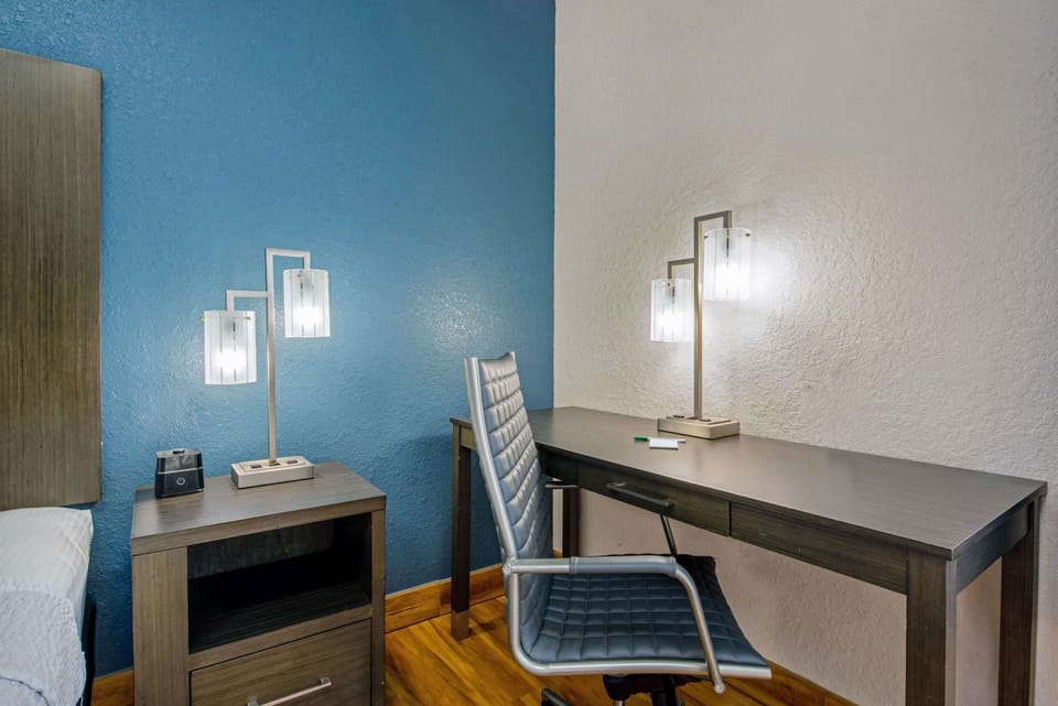 Premium bedding, desk, laptop workspace, blackout drapes