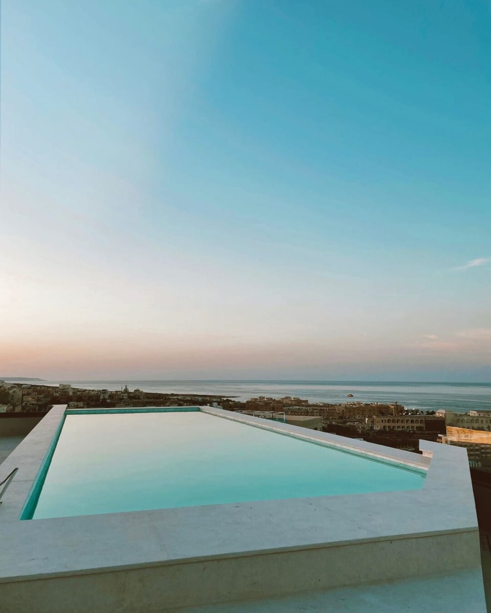 Seasonal outdoor pool, open 10:00 AM to 7:00 PM, pool umbrellas