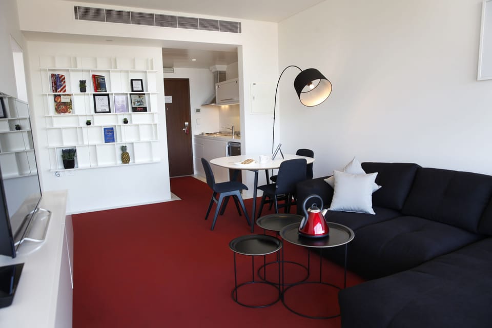 Junior Suite, City View | Living room | Flat-screen TV, DVD player, pay movies
