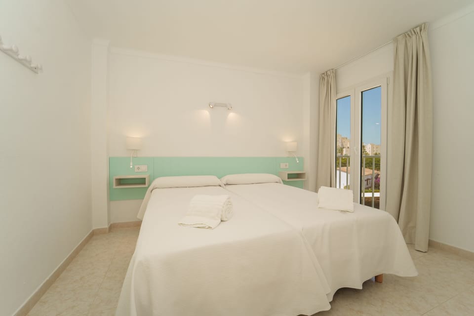 Apartment, 1 Bedroom, Balcony, Sea View | 1 bedroom, desk, blackout drapes, iron/ironing board