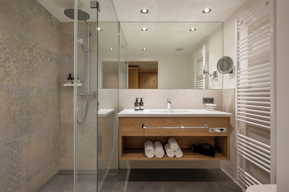 Shower, rainfall showerhead, hair dryer, towels