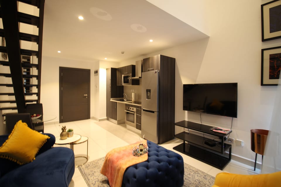 Deluxe Duplex | Living area | Flat-screen TV