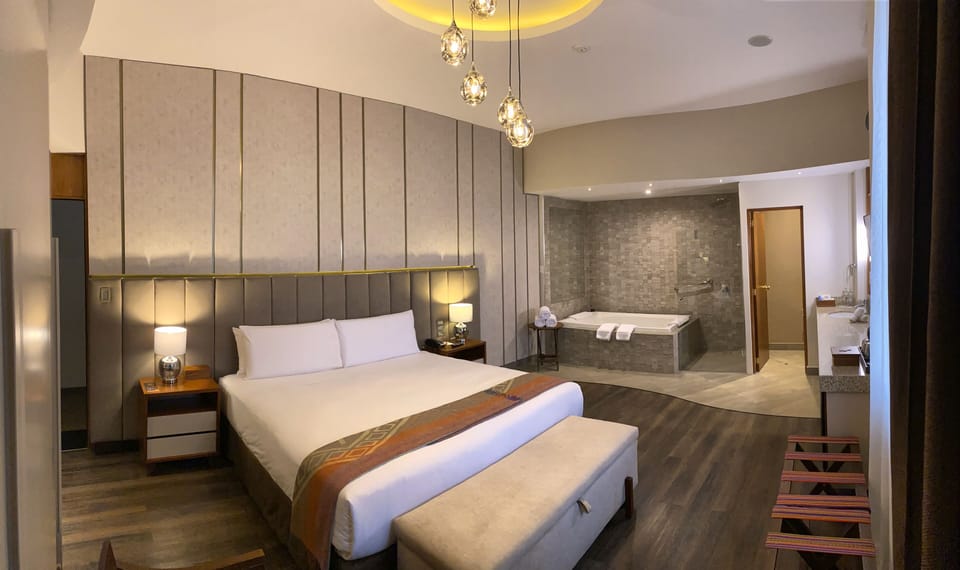 Deluxe Suite, 1 King Bed, Jetted Tub, City View | Premium bedding, down comforters, pillowtop beds, minibar