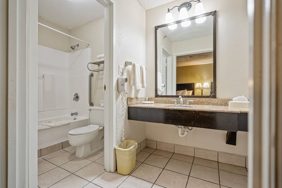 Bathtub, designer toiletries, hair dryer, bathrobes