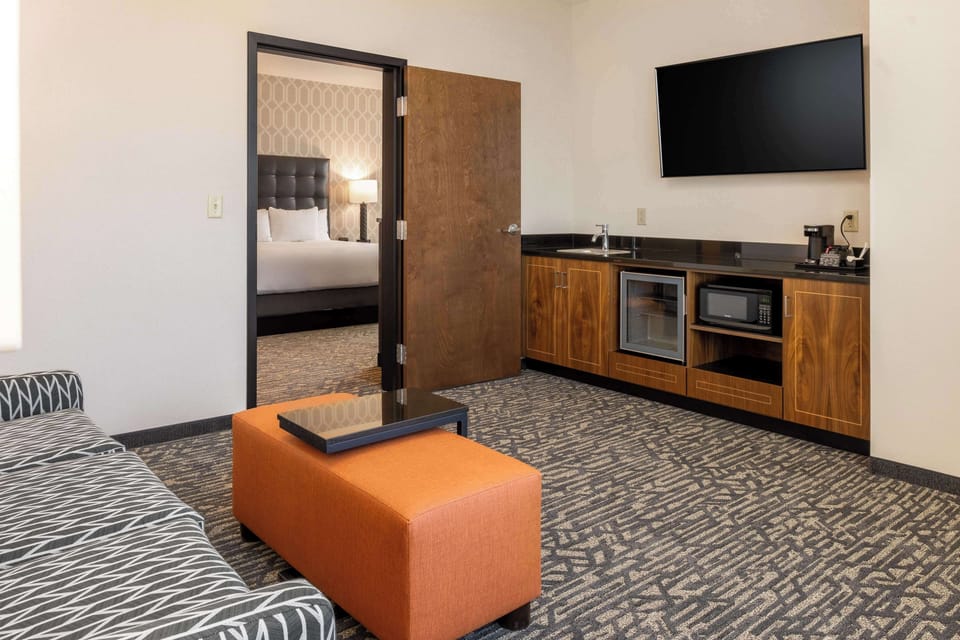 Premium bedding, desk, laptop workspace, blackout drapes