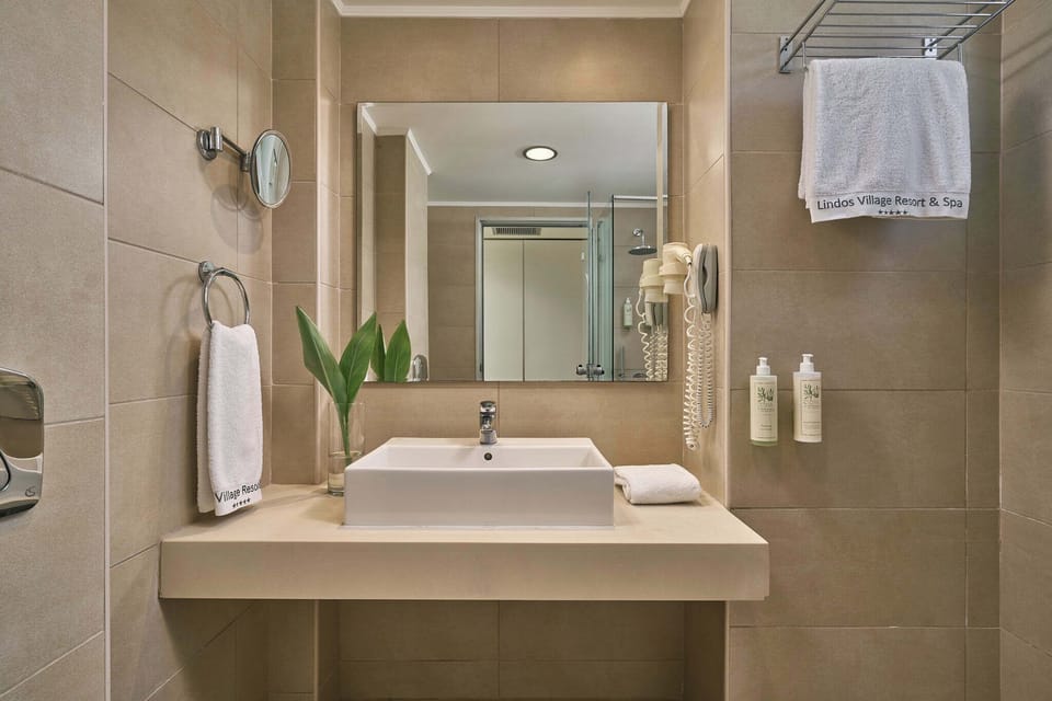 Designer toiletries, hair dryer, bathrobes, slippers