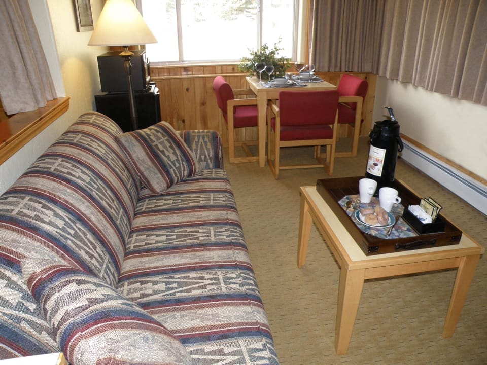 Family Room, 2 Queen Beds | Living area | 32-inch flat-screen TV with digital channels, TV