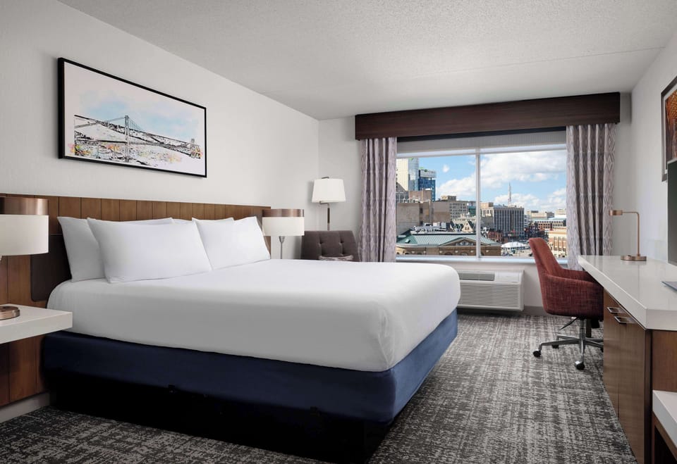 Premium bedding, desk, laptop workspace, blackout drapes