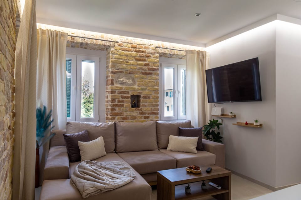 Deluxe Apartment | Living area | 50-inch Smart TV with cable channels
