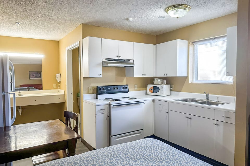 Room, 2 Queen Beds, Non Smoking, Kitchenette | Private kitchenette | Mini-fridge, microwave, coffee/tea maker, dining tables