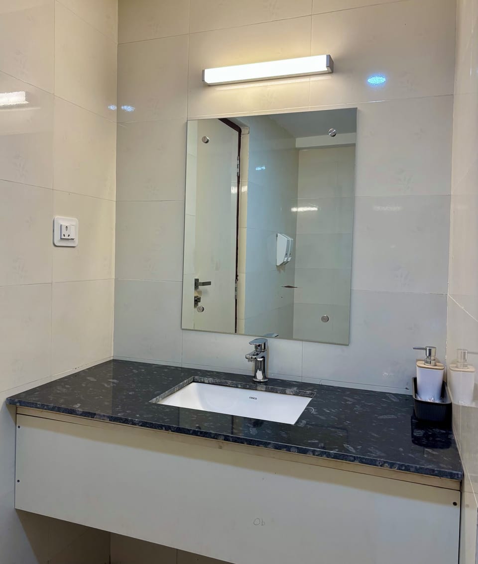 Shower, hair dryer, slippers, towels