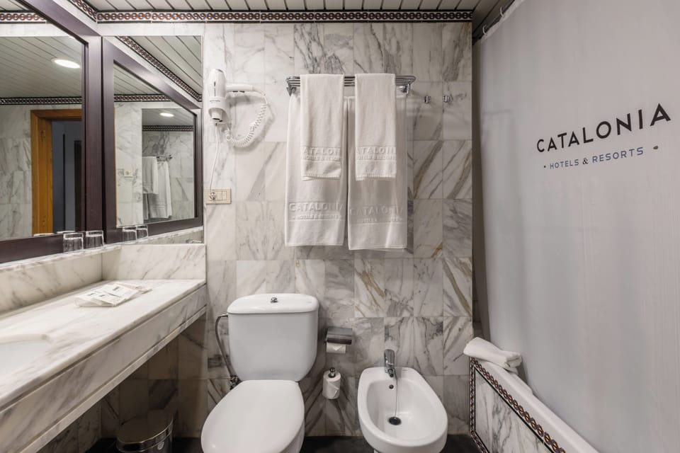Bathtub, eco-friendly toiletries, hair dryer, towels