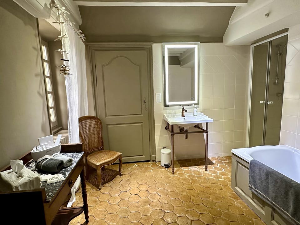 Separate tub and shower, designer toiletries, hair dryer, bathrobes