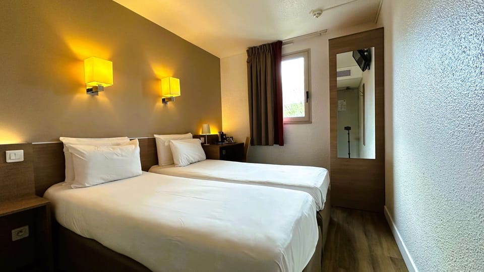 Premium bedding, desk, laptop workspace, blackout drapes