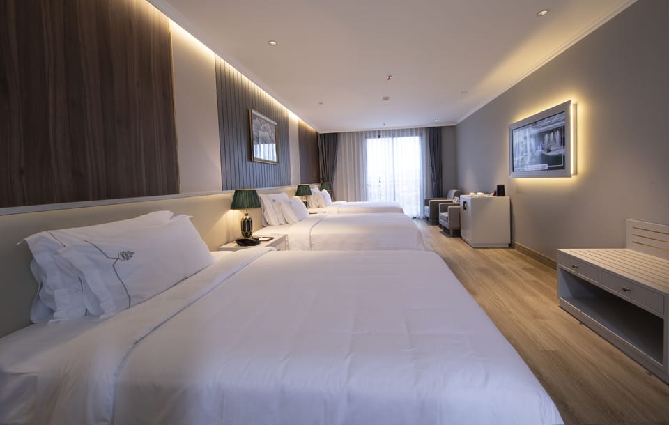Deluxe Triple Room | Minibar, in-room safe, desk, laptop workspace
