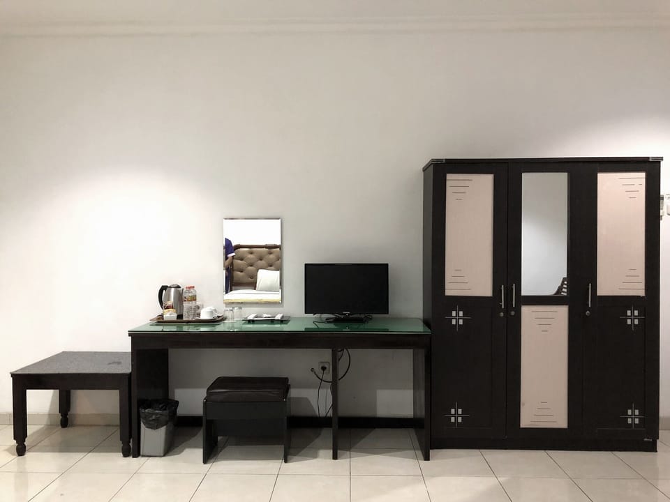 Standard Room | Living area | 32-inch LED TV with cable channels, TV
