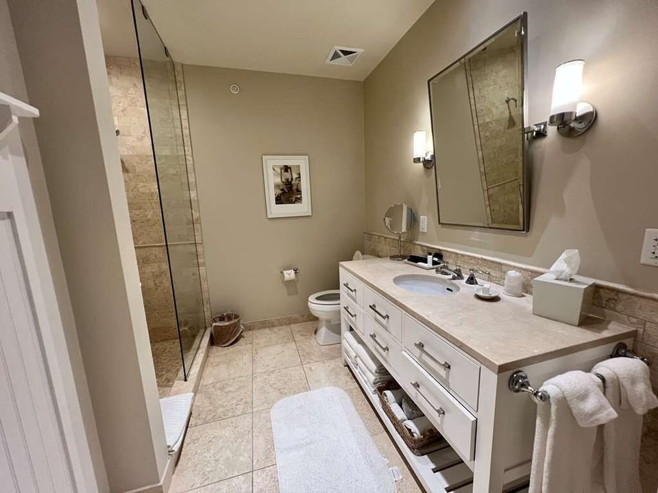 Shower, designer toiletries, hair dryer, bathrobes