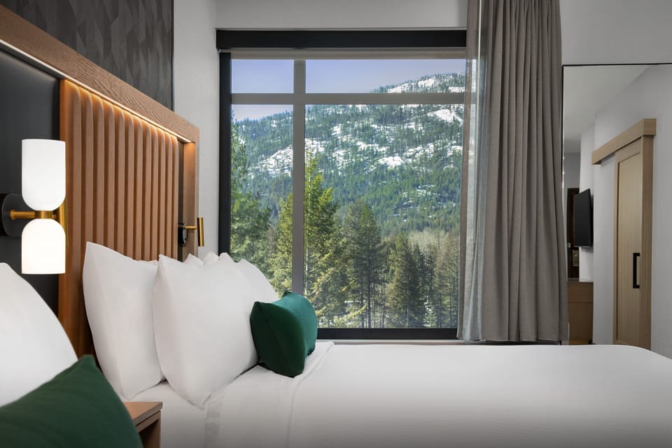 Hypo-allergenic bedding, desk, laptop workspace, blackout drapes