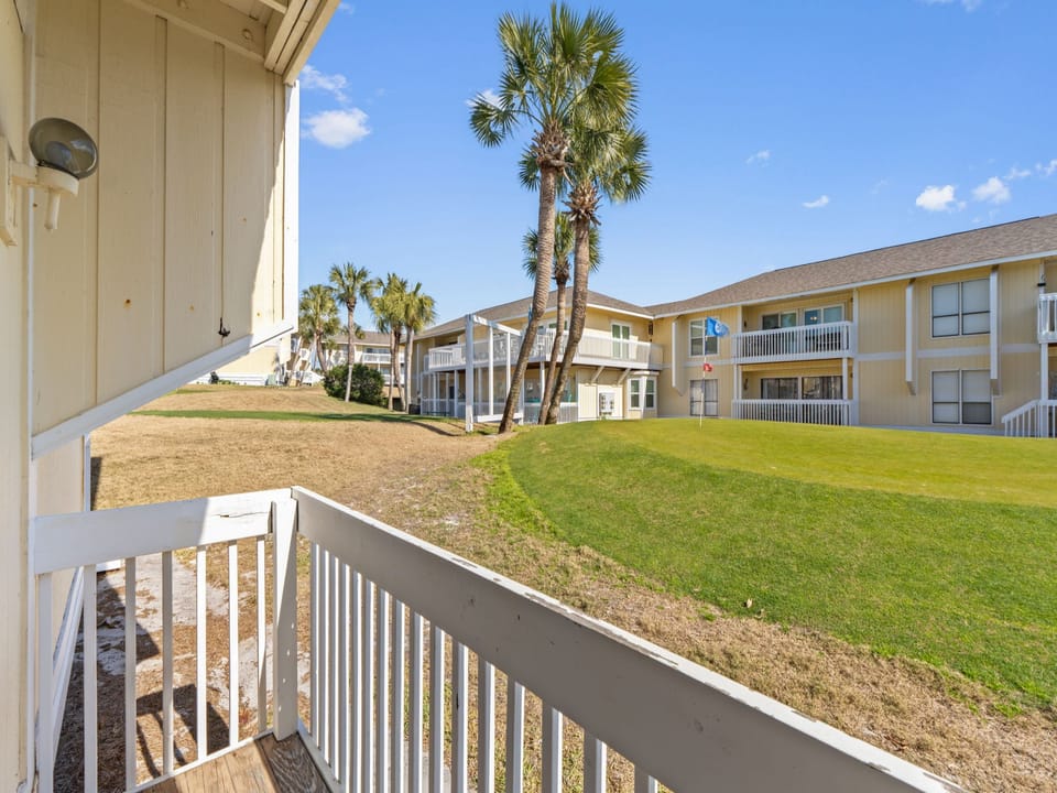 Enjoy peaceful resort views from the private patio overlooking the lush grounds and golf course area at Sandpiper Cove Resort. This relaxing outdoor space is perfect for morning coffee, evening drinks, and soaking in the coastal atmosphere.