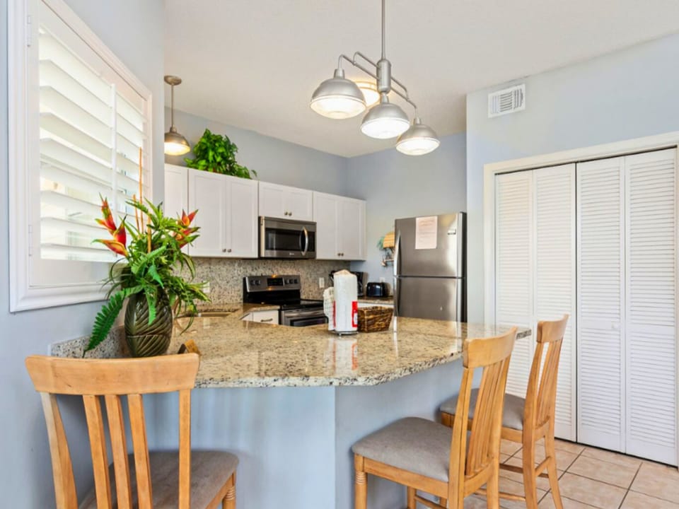 Bright Coastal Kitchen with Granite Counters & Breakfast Bar Seating