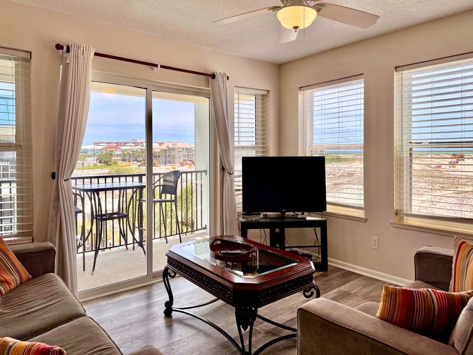 Relax in your bright living space where water views frame every moment. Unwind on plush seating, enjoy entertainment on the flat-screen TV, and step onto your private balcony to soak in the coastal scenery.