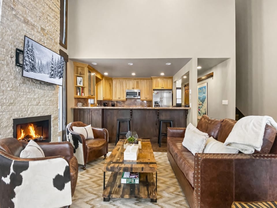 Relax in this cozy living space featuring comfortable leather furniture and a large coffee table. The perfect spot to unwind after a day of Park City adventure.