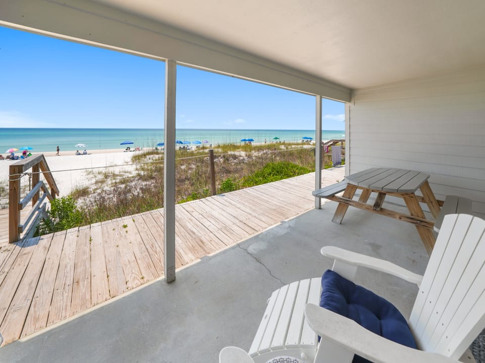 Three Steps to the Beach | Fully Furnished Walkout Deck | Lounge Chairs | Outdoor Dining Area | Overlooking the Beach