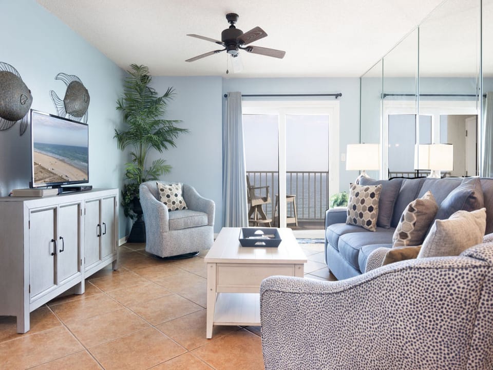 Unwind in the living area, where breathtaking views of the Gulf create a captivating backdrop for your relaxation.