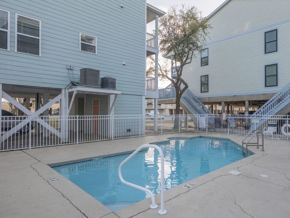The complex features a pool for you to relax by and enjoy after being on the beach.