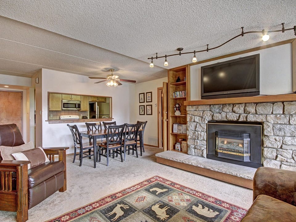 Open concept living and dining room table, fireplace, and TV