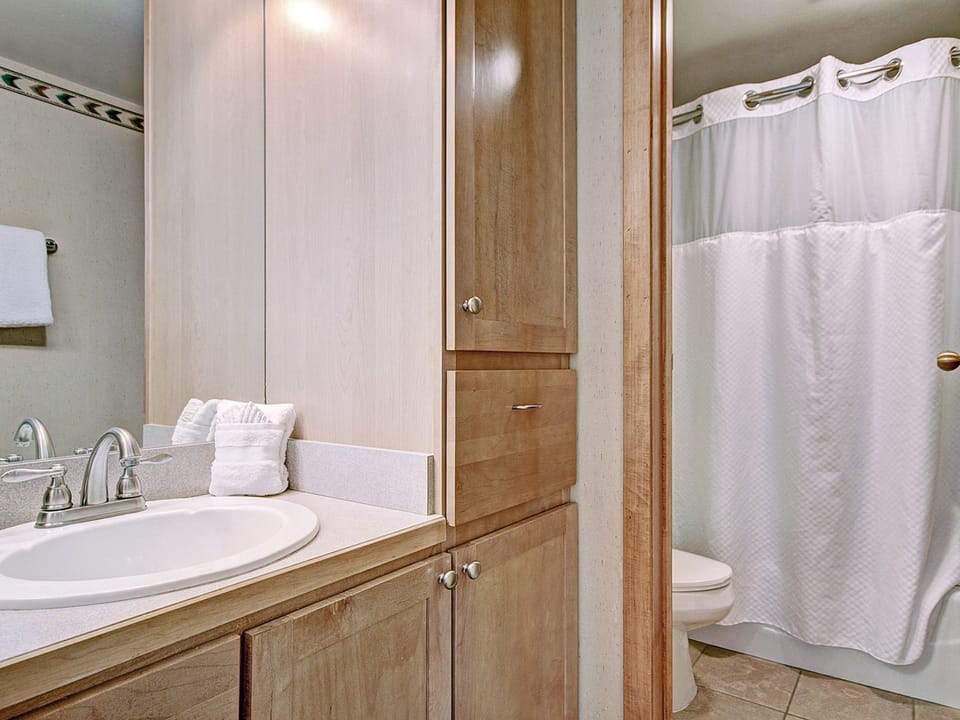 Bathroom with vanity area and separate toilet/shower room.