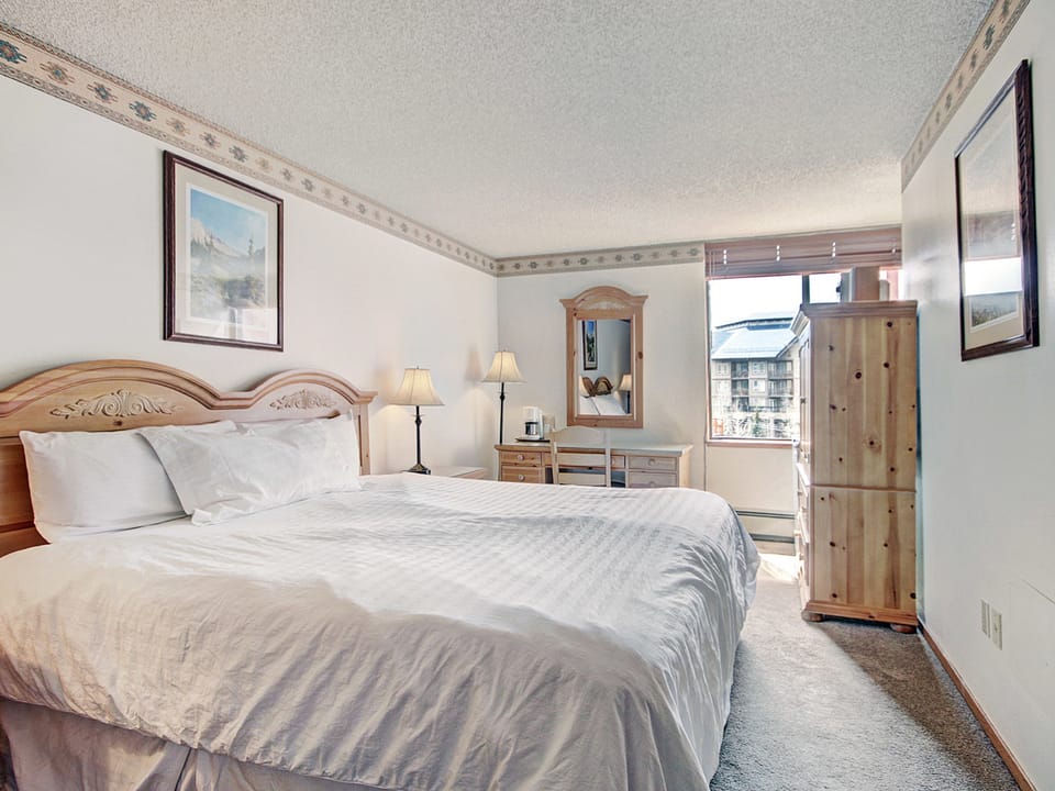 Hotel room featuring a cozy king bed.
