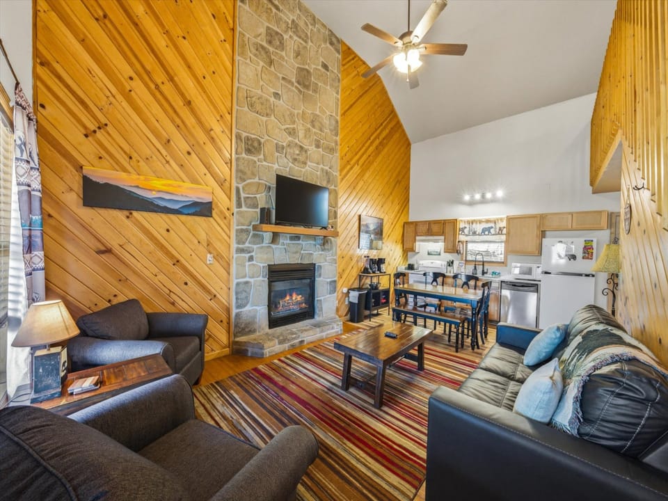 Cozy up by your stone fireplace in this rustic retreat with vaulted ceilings and warm wood walls that create the perfect mountain getaway.