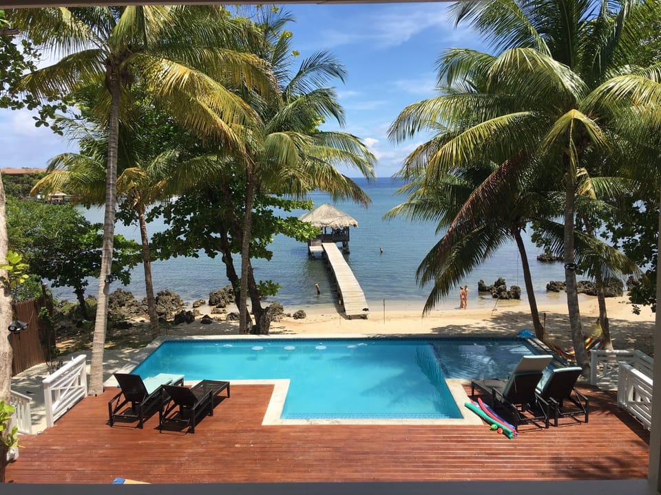 View from the house of the pool, beach and dock.