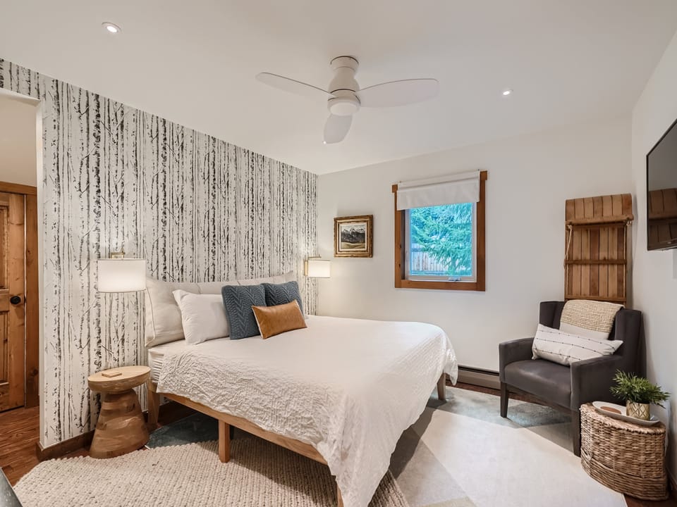 King primary suite with walk-in closet and Smart TV