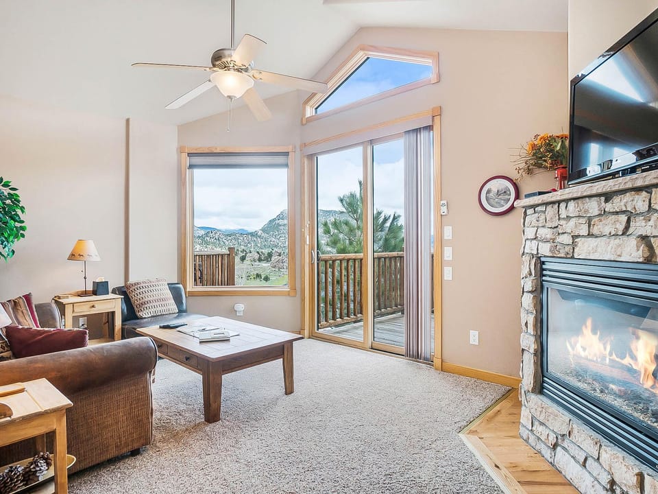 Teepee Mountain 12A  - Living room with queen sleeper sofa, leather chair, fireplace and flat screen TV.  Open up the sliding door for fresh mountain air.