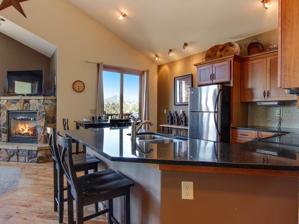 The Twin Owls 21A - The well equipped kitchen looks out into the living room with fireplace and flat screen TV