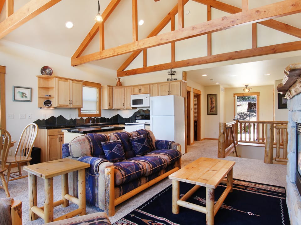 Comanche Peak 39 - Spacious living area with queen sleeper sofa, fireplace, and flat-screen TV adjacent to the kitchen and dining area.
