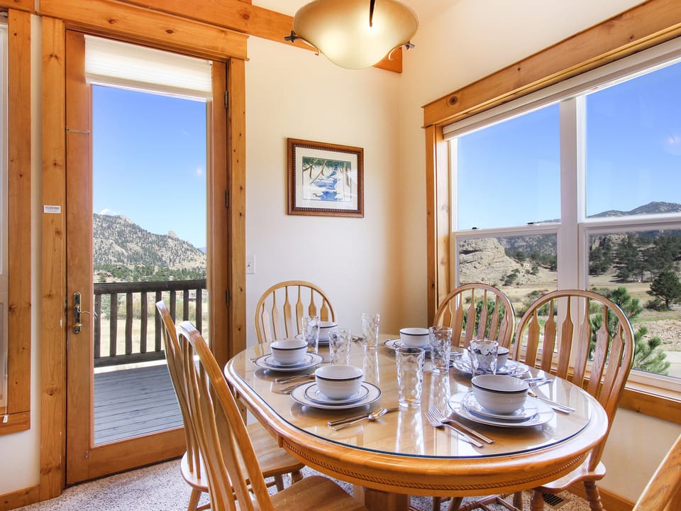 Comanche Peak 39 - Dining table with seating for six surrounded by windows and beautiful mountain views.