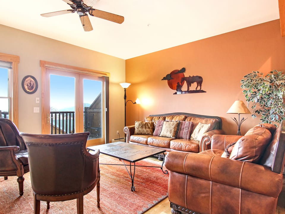 Mount Chapin S4 - Main living space area with three-cushion sofa, loveseat, and two armchairs. Plenty of space to relax with loved ones around the beautiful stone fireplace.